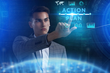 The concept of business, technology, the Internet and the network. A young entrepreneur working on a virtual screen of the future and sees the inscription: action plan