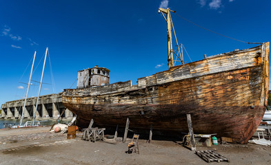 Old wooden fishing boat in a repair yard beside the World War 2 BETASOM submarine base in Bordeaux, France
