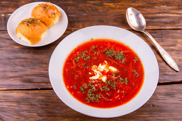  Borsch with greens and sour cream, is served with dumplings garlick