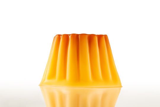 Juicy udding or creme caramel isolated over white background.