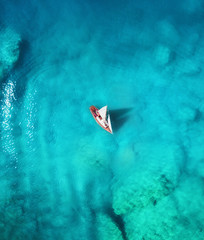 Yacht on the sea from top view. Turquoise water background from top view. Summer seascape from air. Travel concept and idea