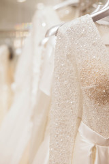 Large selection of dresses in the wedding salon. 