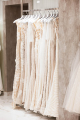Large selection of dresses in the wedding salon. 