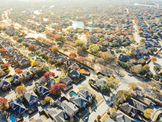 Top view colorful lakeside urban sprawl residential area near Dallas in autumn season