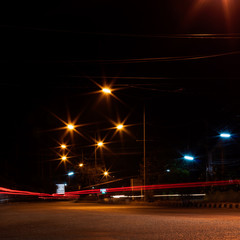 Fototapeta na wymiar Car headlights and night street lamps.
