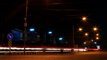 Fototapeta na wymiar Car headlights and night street lamps.