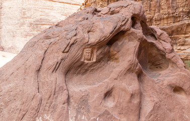 Portrait of Lawrence of Arabia and his name in Arabic carved in stone in the Wadi Rum desert near...