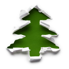Christmas tree shaped green hole torn through paper, isolated on white background