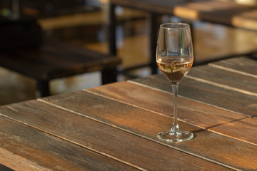 a glass of wine on the table in a street cafe