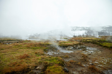 Steam Rising From Geothermal Pools In Icelandic Countryside