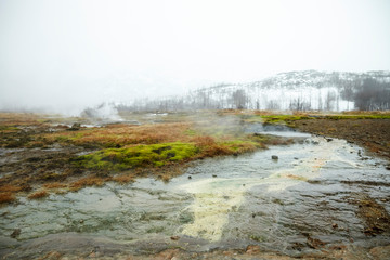 Steam Rising From Geothermal Pools In Icelandic Countryside