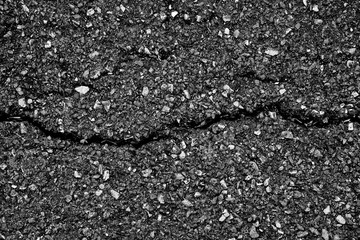 crack and texture of asphalt road - top view background.