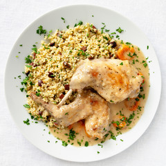 floured and quikly fried rabbit legs stewed with apricots garnished with boiled, parsley and olives added wheat 