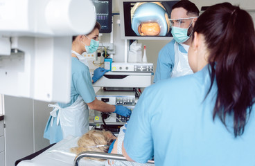 Doctor during endoscopy checking picture of mouth on screen