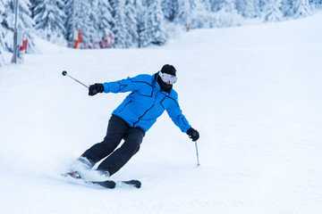 Fototapeta na wymiar Skier skiing downhill in high mountains.