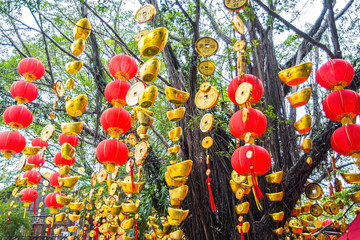High red lanterns and gold ingots hanging on the tree / Chinese New Year background material