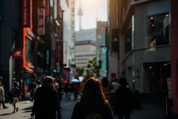 Young asian woman traveler traveling and shopping in Myeongdong street market at Seoul, South Korea. Myeong Dong district is the most popular shopping market at Seoul city.