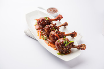 Szechuan Chicken which is a popular Indo-Chinese non vegetarian recipe. served in a plate with...