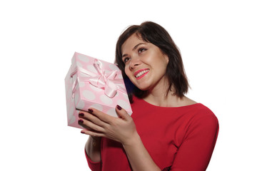 brunette in a red dress with a present in her hands. pink gift box