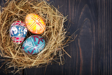 Fototapeta na wymiar Easter eggs in the nest on a wooden table.