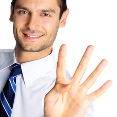 Businessman showing four fingers, isolated