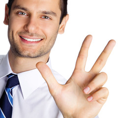 Businessman showing three fingers, isolated