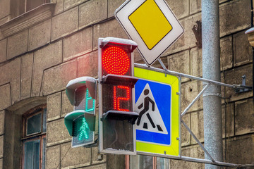 traffic lights with numbers and signs pedestrians and main road in an urban environment