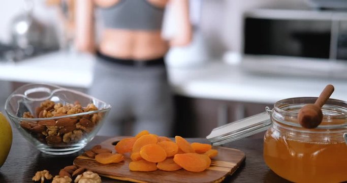 Young woman is prepare healthy food after a workout.