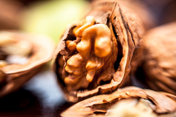 Macro shot of raw organic walnuts in sell on wooden surface.