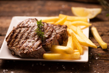 Grilled beef steak on wooden cutting board