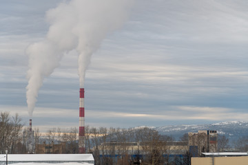 Smoky factory pipes with acrid smoke in the winter. The standard problem of pollution of the...