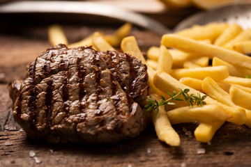 Grilled beef steak on wooden cutting board