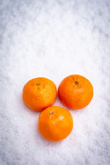 Fruits on the snow, mandarines, apples, pear