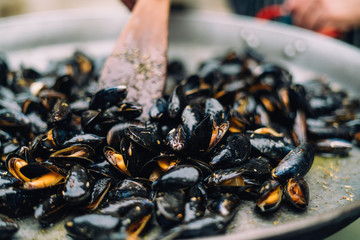 Mussels being baked in a big pan
