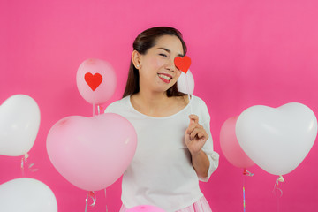 valentine day concept. Beautiful smiley asia girl with pink background copy space isolated.