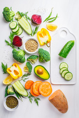 Vegan food background. Balanced food ingredients on white background. Vegetables, legumes for cooking healthy salad.