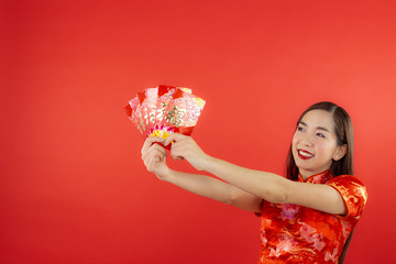 chinese new year beautiful happy smiley asia chiness girl ware Qipao Oriental Chic Cheongsam with red background copy space isolated