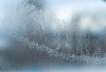 Christmas patterns on the window from cold weather. Outside the winter.