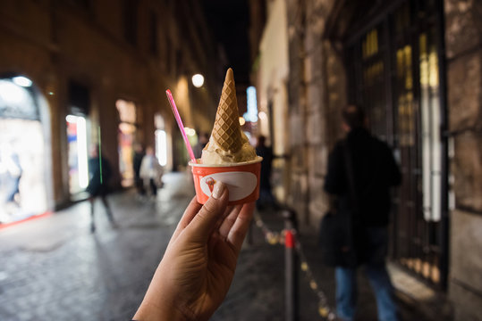 Woman hand holding a cup of Italien ice cream