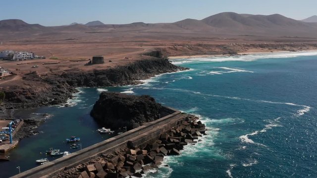 Panning aerial shot of El Cotillo harbour