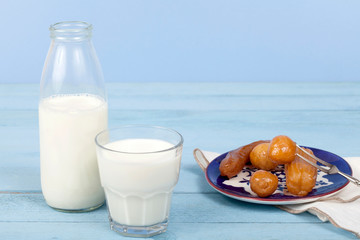 milk and turkish dessert over blue wooden table