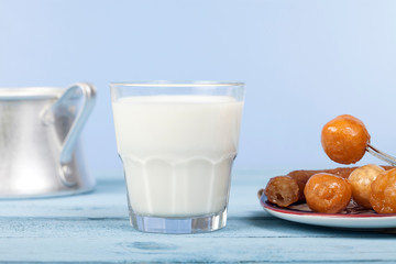 milk and turkish dessert over blue wooden table