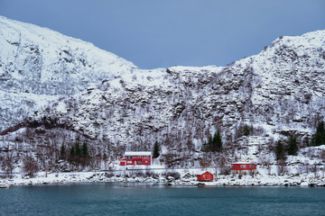 Red rorbu houses in Norway in winter