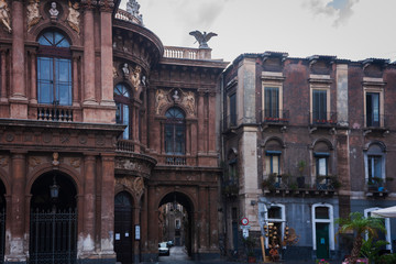 Fototapeta na wymiar Travel to Italy - historical street of Catania, Sicily, facade of ancient buildings.