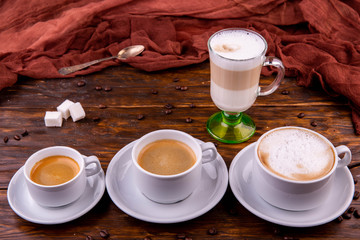 Latte, a cappuccino, an americana and espresso with sugar pieces