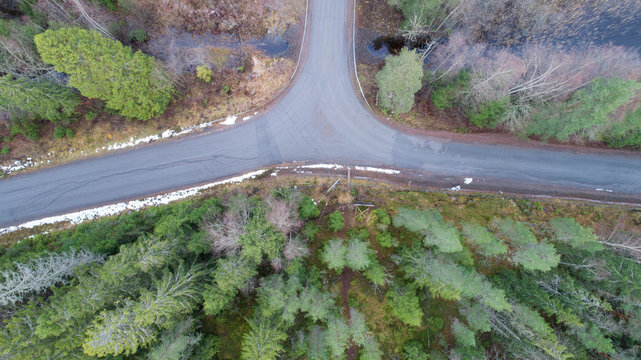 Aerial view of the contry road intersection in the forest