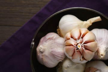 Garlic and garlic cloves on dark.