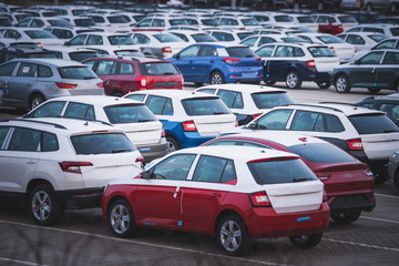 Rows of identical cars in industrial zone