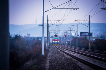 Fototapeta na wymiar Train ride on the track in dark evening light, travel, transport photo