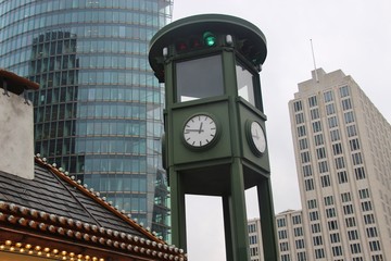 Skyscrapers, clock and christmas stall on the city square Potsdamer Platz in Berlin, Germany,...
